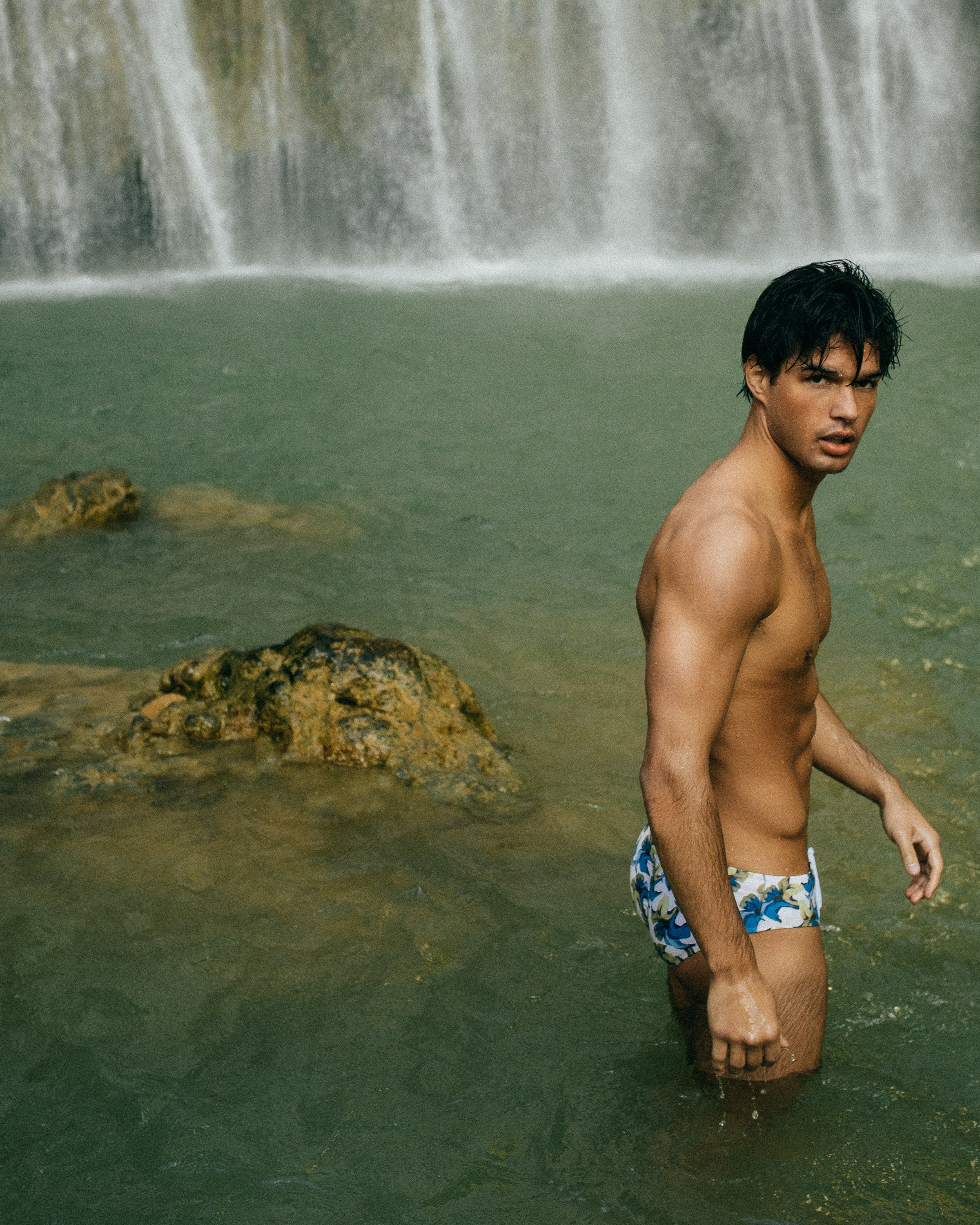 Man in Parke & Ronen Meridian Print Bikini in standing in tropical lagoon