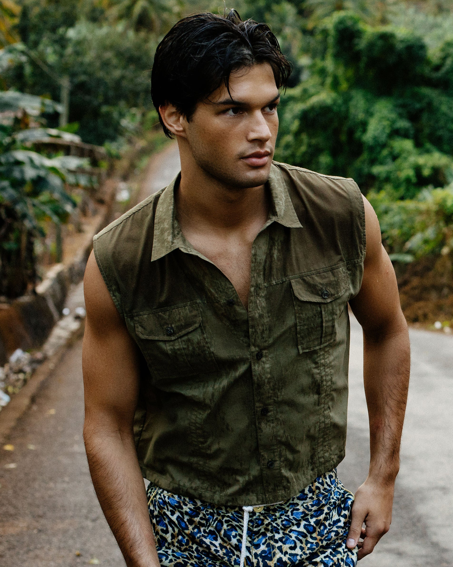 Parke & Ronen Spring Summer 2025 summer sale. Man wears sleeveless tan button down shirt.