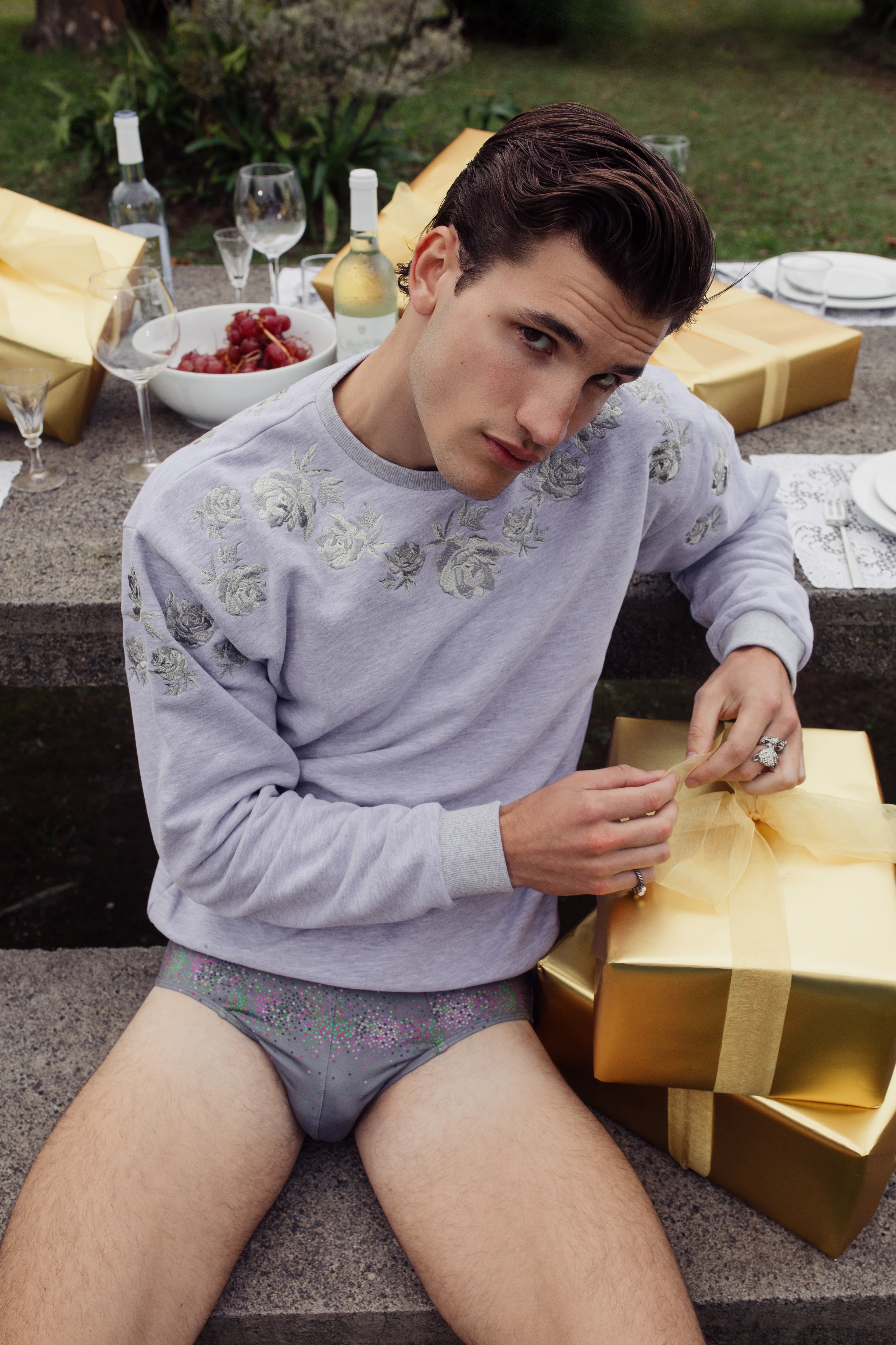 Parke & Ronen Resort 2024 campaign image. Male model wears Varsity Grey embroidered crew neck.
