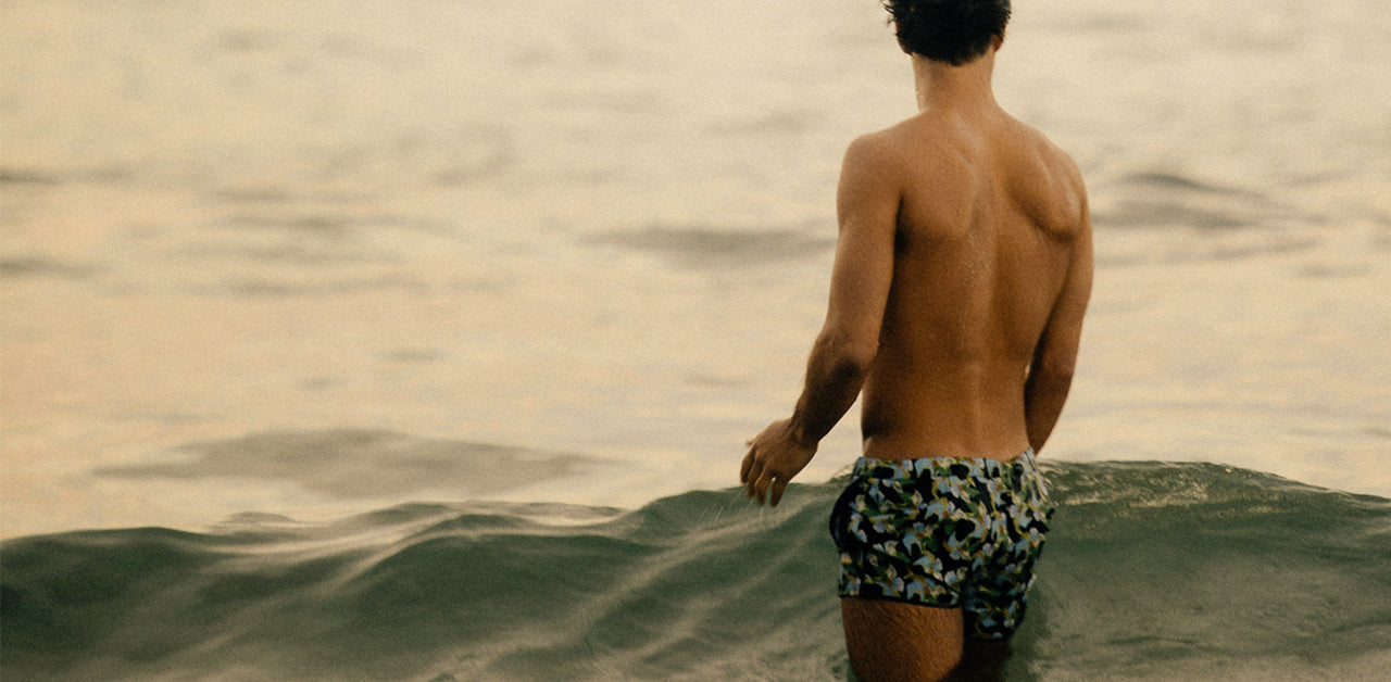 Young man swimming and laughing