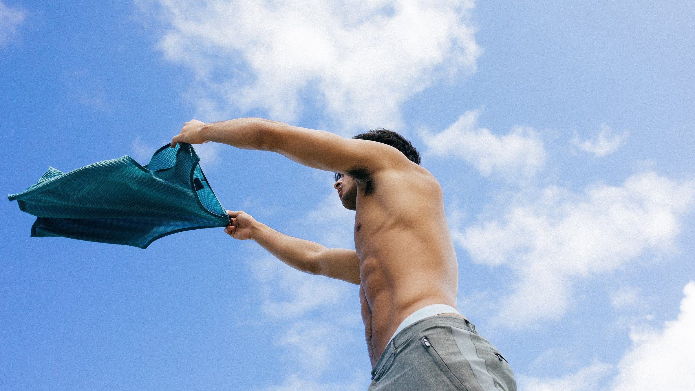 Parke & Ronen Spring 2024 Actionwear image. Male model wears mesh tank and chambray blue runner shorts.