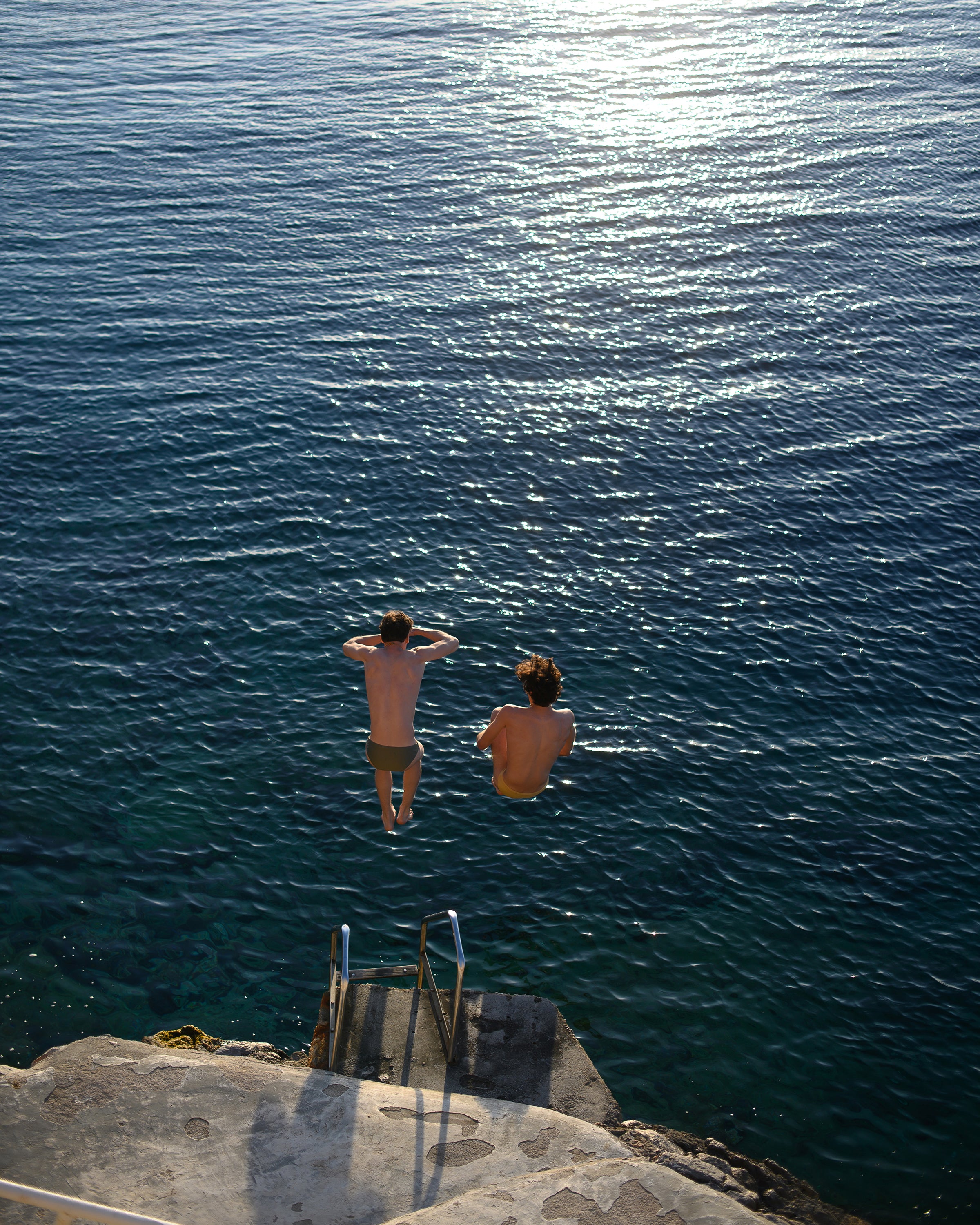 Parke & Ronen Summer Swim Campaign.  2 Male models cliff jumping, wearing the Blade bikini briefs.